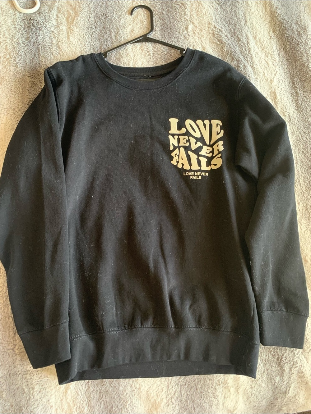 Love Never Fails Black Graphic Crewneck Sweater